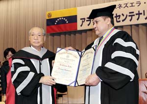 UBA Rector Guarisma presents Mr. Ikeda with the certificates of honorary doctorate