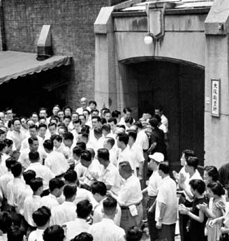 Soka Gakkai members greet Ikeda after his release from the Osaka detention house on July 17, 1957